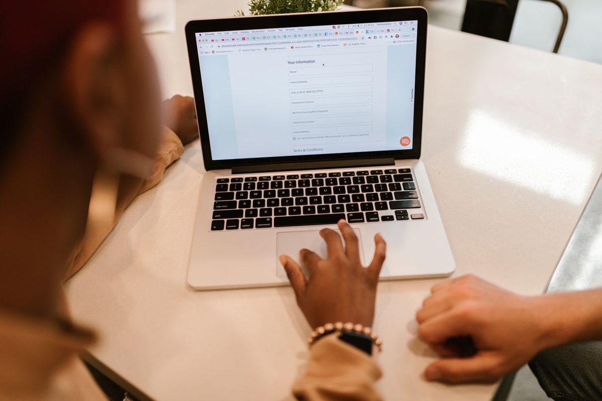 Person filling in an online form on a laptop
